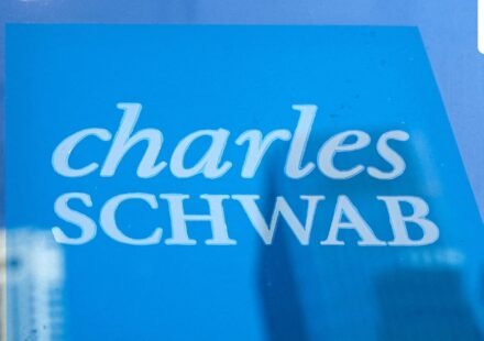 The company logo of Charles Schwab is displayed at a location in the financial district in New York. (REUTERS)