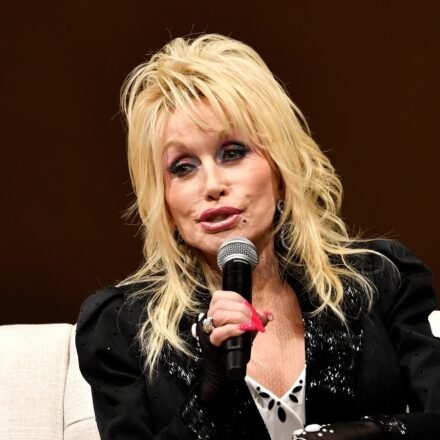 Dolly Parton speaks to a audience gathered to celebrate the expansion of the Imagination Library of Kentucky at the Lyric Theatre in Lexington, Ky. (AP Photo/Timothy D. Easley)