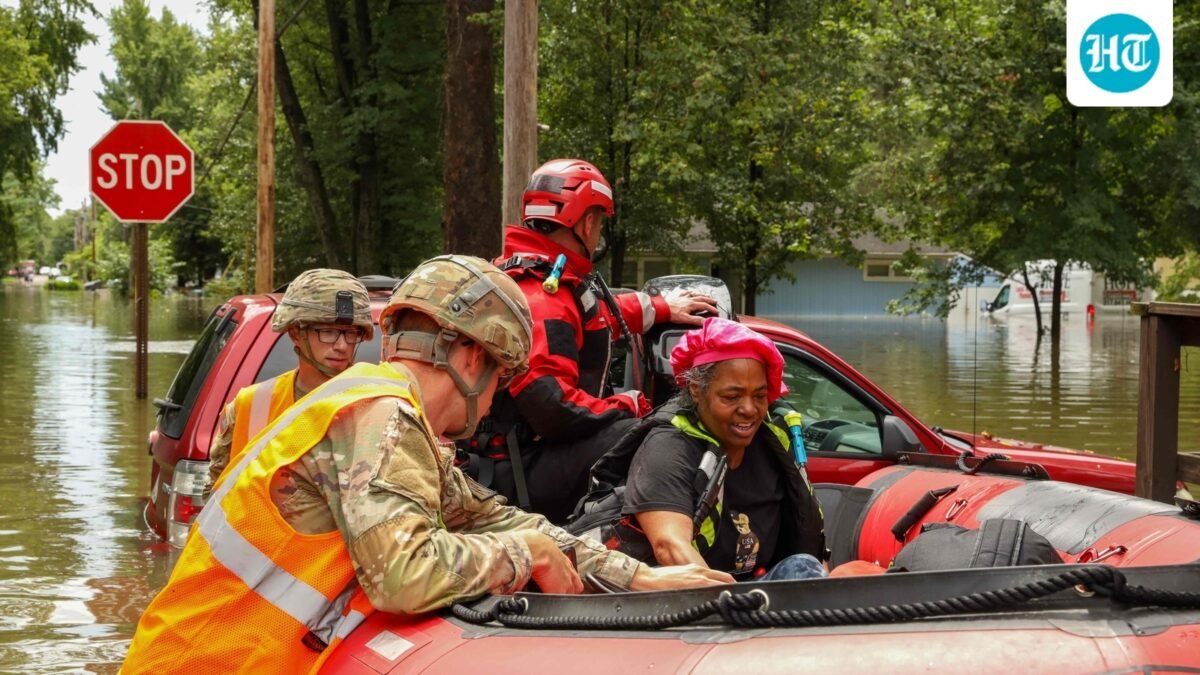 This handout photo distributed by the Indianapolis Fire Department shows first responders helping a resident in flood waters in Indianapolis, Indiana, on August 15. (AFP)