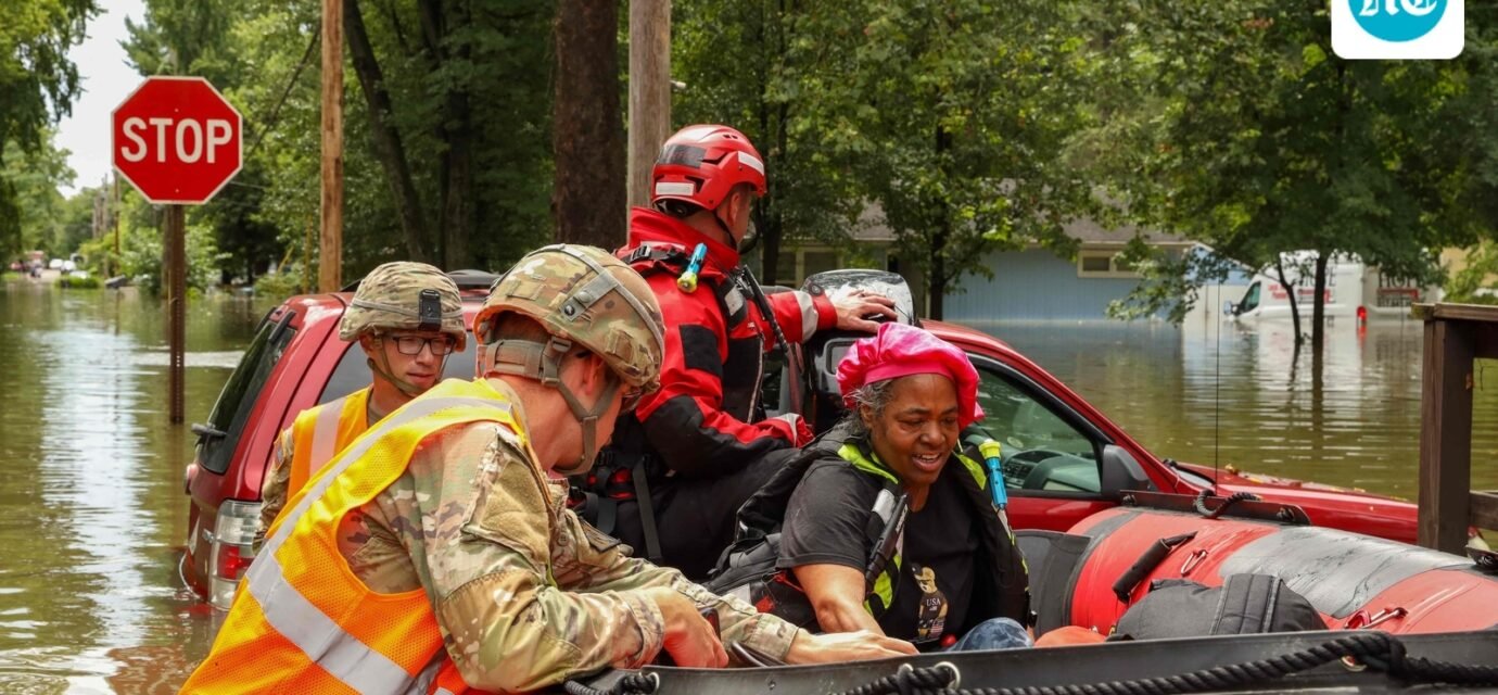 This handout photo distributed by the Indianapolis Fire Department shows first responders helping a resident in flood waters in Indianapolis, Indiana, on August 15. (AFP)
