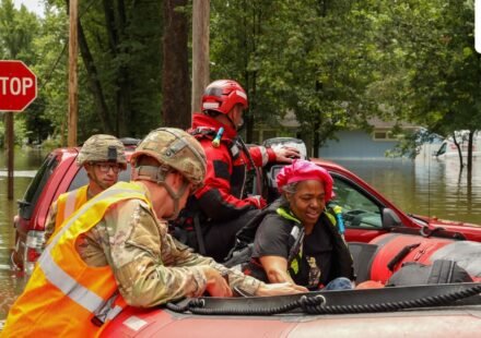 This handout photo distributed by the Indianapolis Fire Department shows first responders helping a resident in flood waters in Indianapolis, Indiana, on August 15. (AFP)
