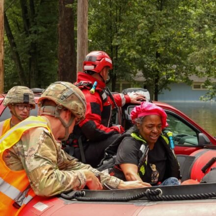 This handout photo distributed by the Indianapolis Fire Department shows first responders helping a resident in flood waters in Indianapolis, Indiana, on August 15. (AFP)