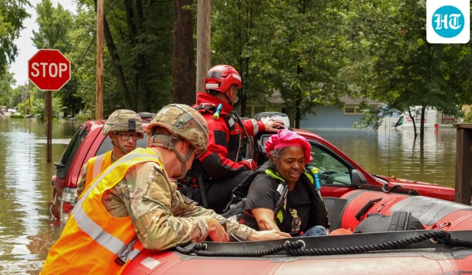 This handout photo distributed by the Indianapolis Fire Department shows first responders helping a resident in flood waters in Indianapolis, Indiana, on August 15. (AFP)