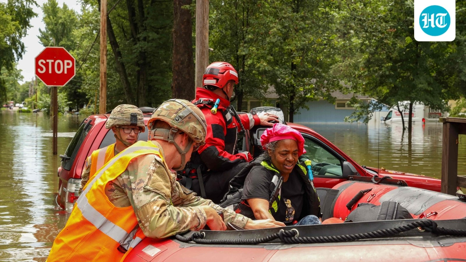 This handout photo distributed by the Indianapolis Fire Department shows first responders helping a resident in flood waters in Indianapolis, Indiana, on August 15. (AFP)