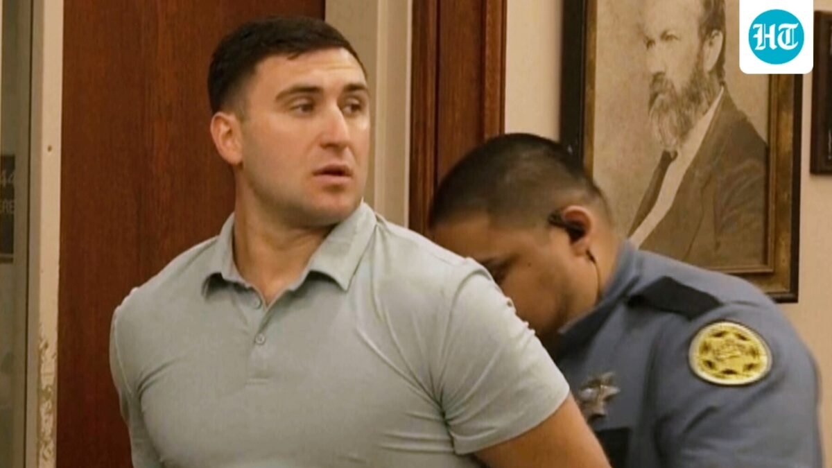 Jake Lang is led out of Judge H. Reid Poland III's courtroom in handcuffs during livestreamer Dalton Eatherly's hearing, Thursday, May 21, 2026, in Clarksville, Tenn. (AP Photo/Kristin Hall)