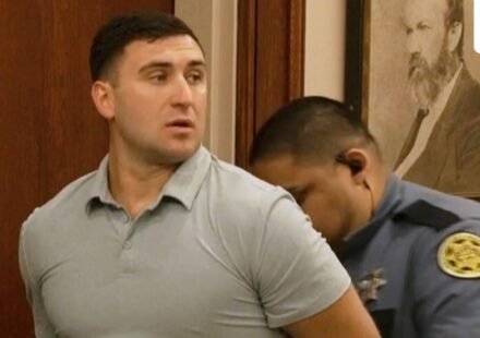 Jake Lang is led out of Judge H. Reid Poland III's courtroom in handcuffs during livestreamer Dalton Eatherly's hearing, Thursday, May 21, 2026, in Clarksville, Tenn. (AP Photo/Kristin Hall)