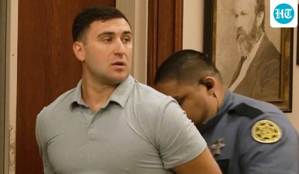 Jake Lang is led out of Judge H. Reid Poland III's courtroom in handcuffs during livestreamer Dalton Eatherly's hearing, Thursday, May 21, 2026, in Clarksville, Tenn. (AP Photo/Kristin Hall)