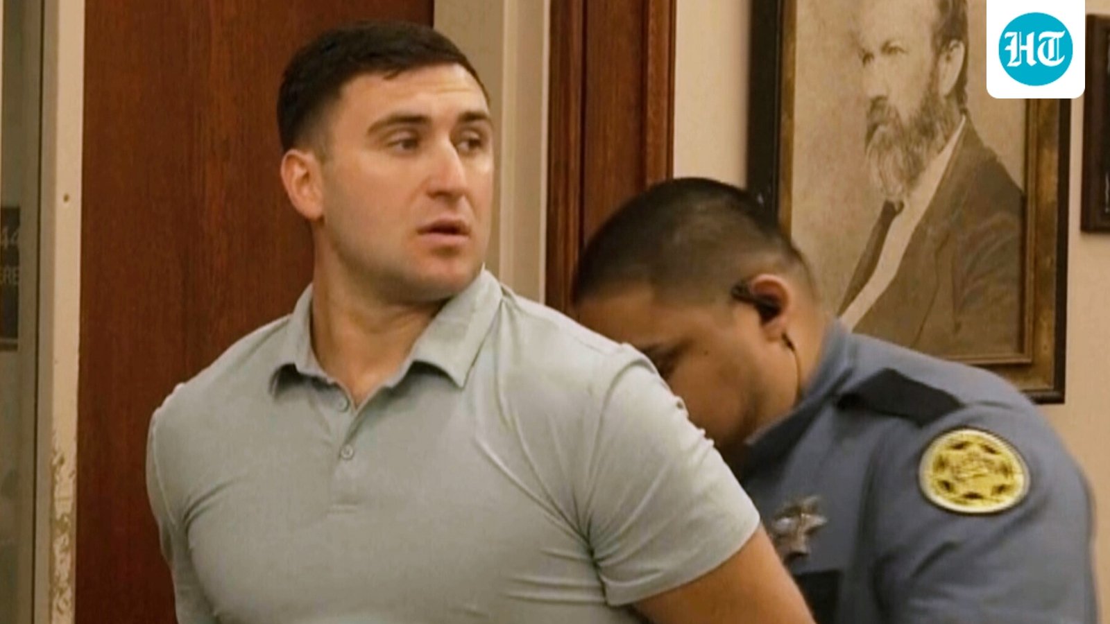 Jake Lang is led out of Judge H. Reid Poland III's courtroom in handcuffs during livestreamer Dalton Eatherly's hearing, Thursday, May 21, 2026, in Clarksville, Tenn. (AP Photo/Kristin Hall)