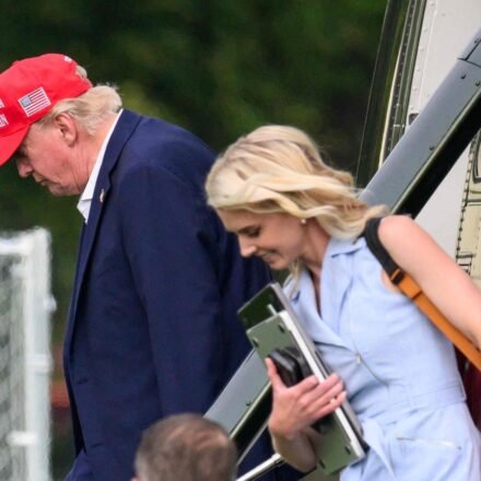 US President Donald Trump and aide Natalie Harp (R) exit Marine One on the Ellipse near the White House on August 16, 2026. (AFP)