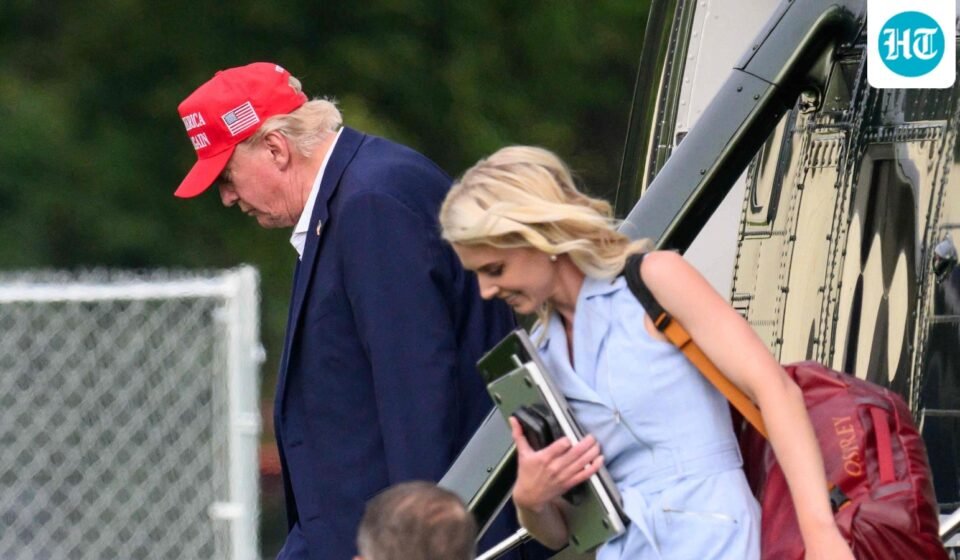 US President Donald Trump and aide Natalie Harp (R) exit Marine One on the Ellipse near the White House on August 16, 2026. (AFP)