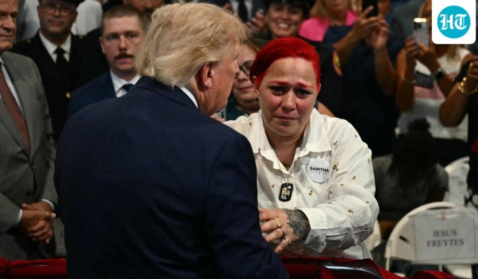 US President Donald Trump leaves stage to hug Jacob Freytes grieving parents. (AFP)