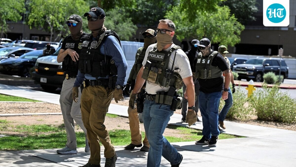 ICE agent pulls gun after Virginia woman confronts officers. (REUTERS)