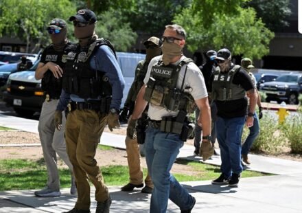 ICE agent pulls gun after Virginia woman confronts officers. (REUTERS)