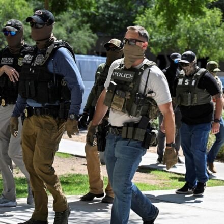 ICE agent pulls gun after Virginia woman confronts officers. (REUTERS)