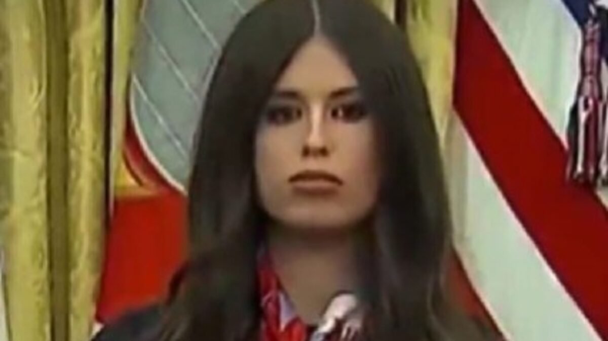 Jayme Franklin's presence behind Trump at a vaccine announcement led to her being humorously labeled as 'AI Bobblehead Barbie' due to her constant nodding.