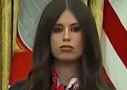 Jayme Franklin's presence behind Trump at a vaccine announcement led to her being humorously labeled as 'AI Bobblehead Barbie' due to her constant nodding.