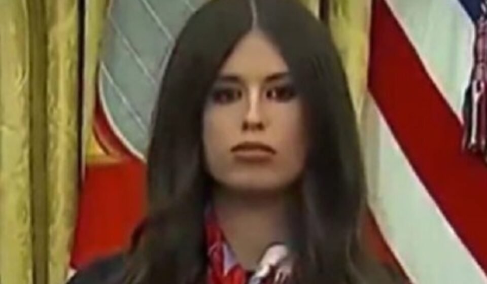 Jayme Franklin's presence behind Trump at a vaccine announcement led to her being humorously labeled as 'AI Bobblehead Barbie' due to her constant nodding.