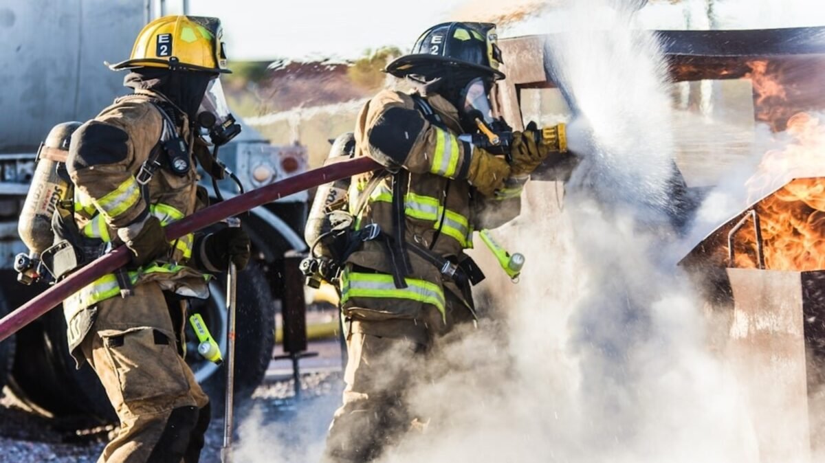 A large smoke plume rises over downtown Dallas as fire crews respond.