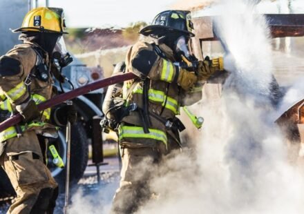 A large smoke plume rises over downtown Dallas as fire crews respond.