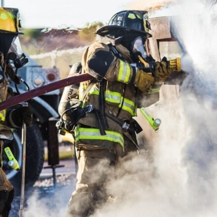 A large smoke plume rises over downtown Dallas as fire crews respond.