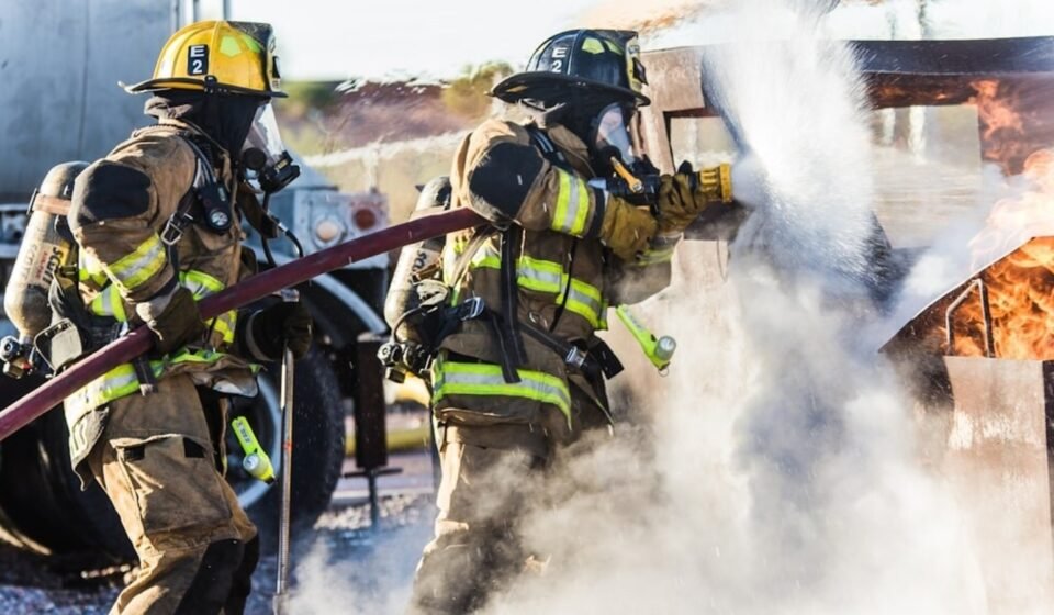 A large smoke plume rises over downtown Dallas as fire crews respond.