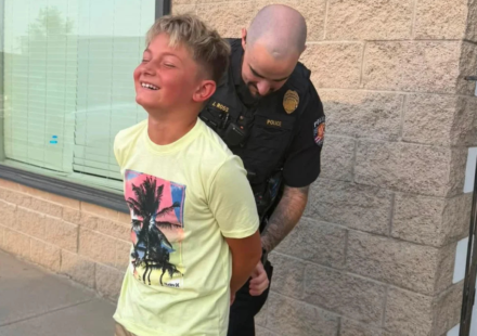 Colorado mom gets her son ‘arrested’ by police after he refuses to take a first-day-of-school photo, with officer handcuffing him in hilarious prank