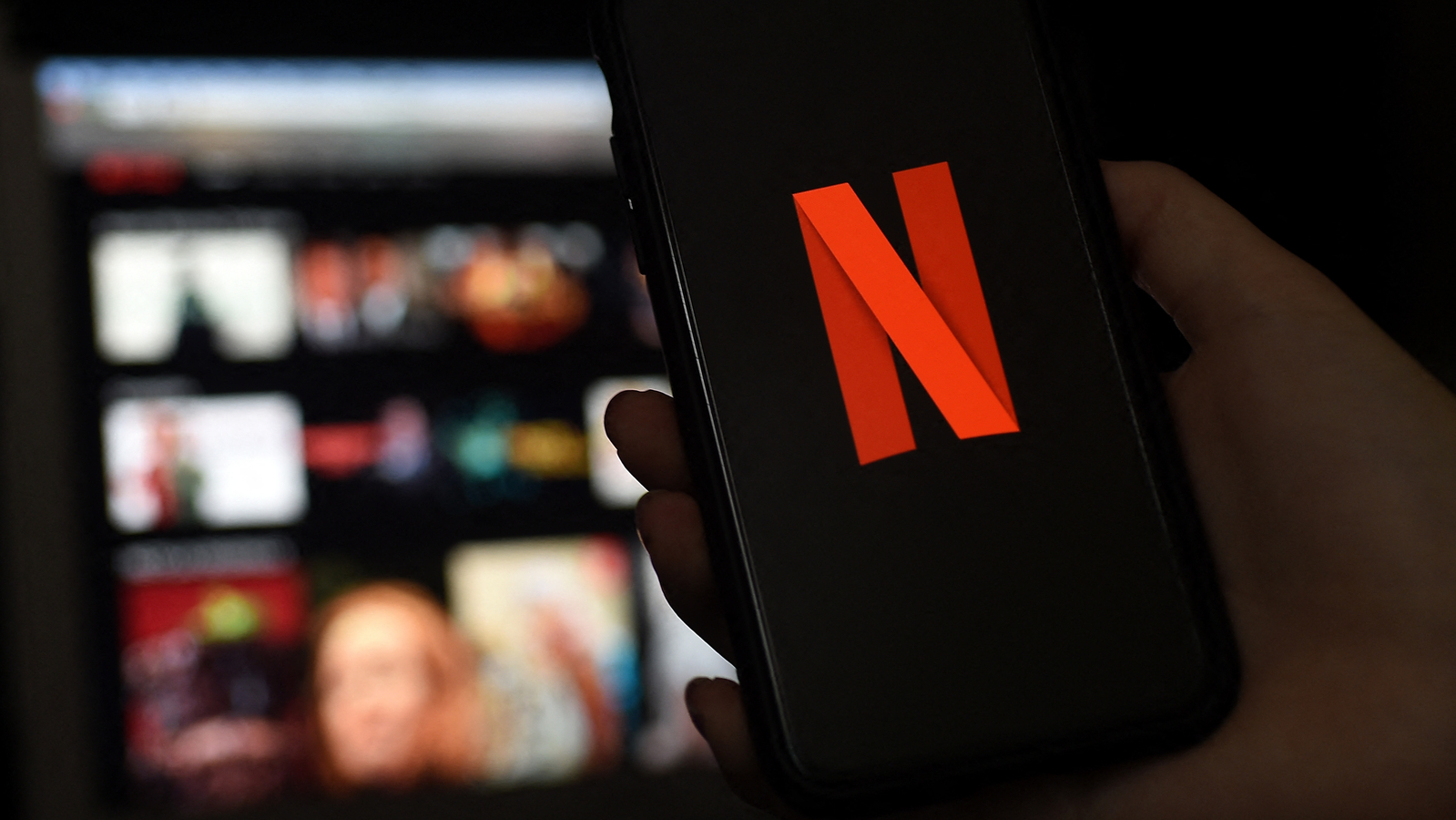 In this file photo illustration a computer and a mobile phone screens display the Netflix logo on March 31, 2020 in Arlington, Virginia. (AFP)