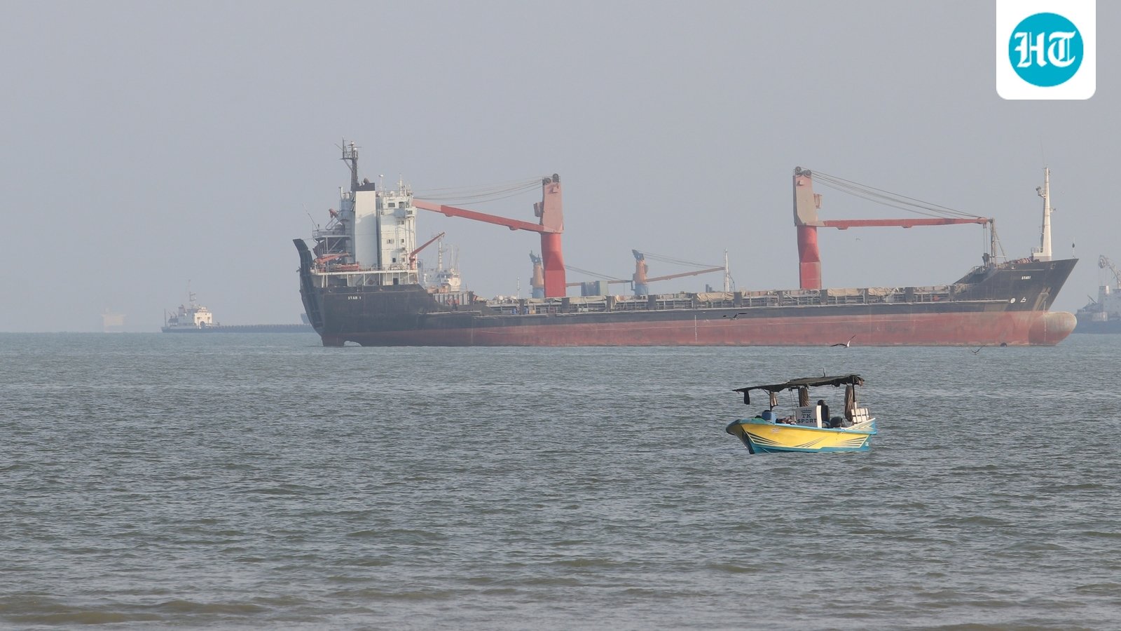 A boat floats as commercial vessels appear anchored in the Strait of Hormuz off Bandar Abbas, Iran, Oct. 13, 2026. (Razieh Poudat/ISNA via AP) (AP Photo/Razieh Poudat)