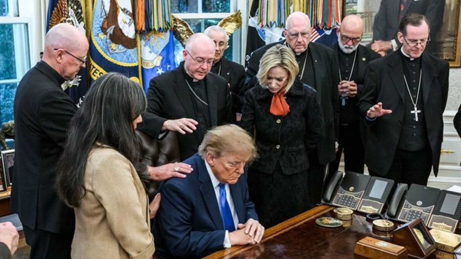 President Donald Trump praying at Oval Office with archbishops and bishops.