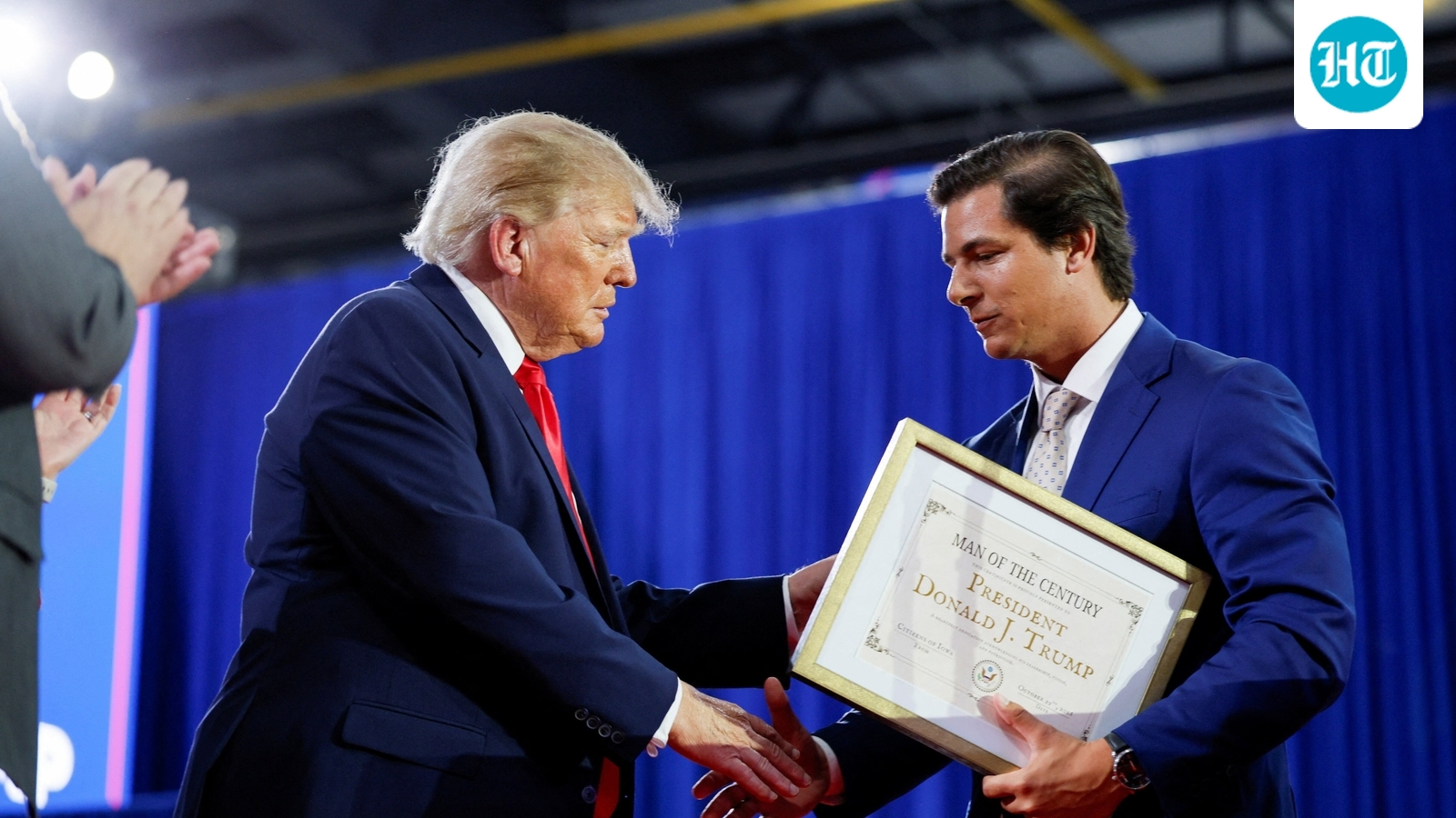 Joe Mitchell presented Trump with a self-created “Man of the Century Award” at an Iowa rally. (REUTERS)
