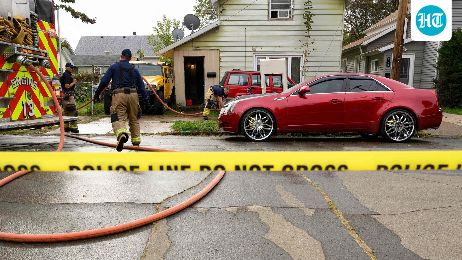 ERIE, PENNSYLVANIA - OCTOBER 10: Firefighters clean blood from outside the home at 722 Perry Street where 9 members of a family were killed in an apparent domestic dispute on October 10, 2026 in Erie, Pennsylvania. (Photo by JEFF SWENSEN / GETTY IMAGES NORTH AMERICA / Getty Images via AFP) (Getty Images via AFP)
