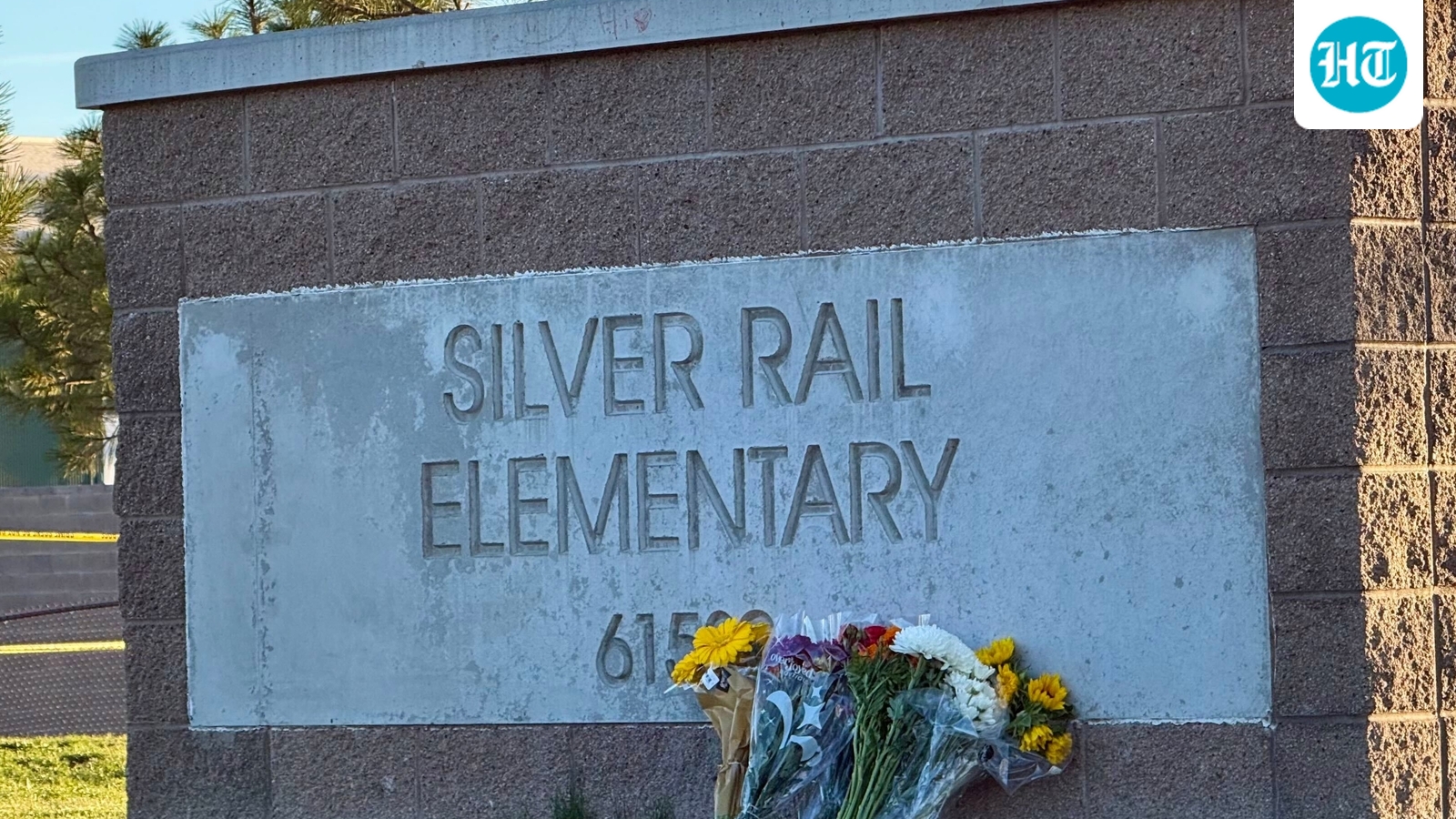 Flowers are placed beside a sign at Silver Rail Elementary School in Bend, Oregon on Friday, Oct. 16. (AP Photo/Haven Daley)