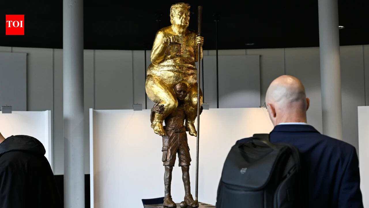 ‘The Orange Plague’: Why a golden, naked Trump is sitting on another man