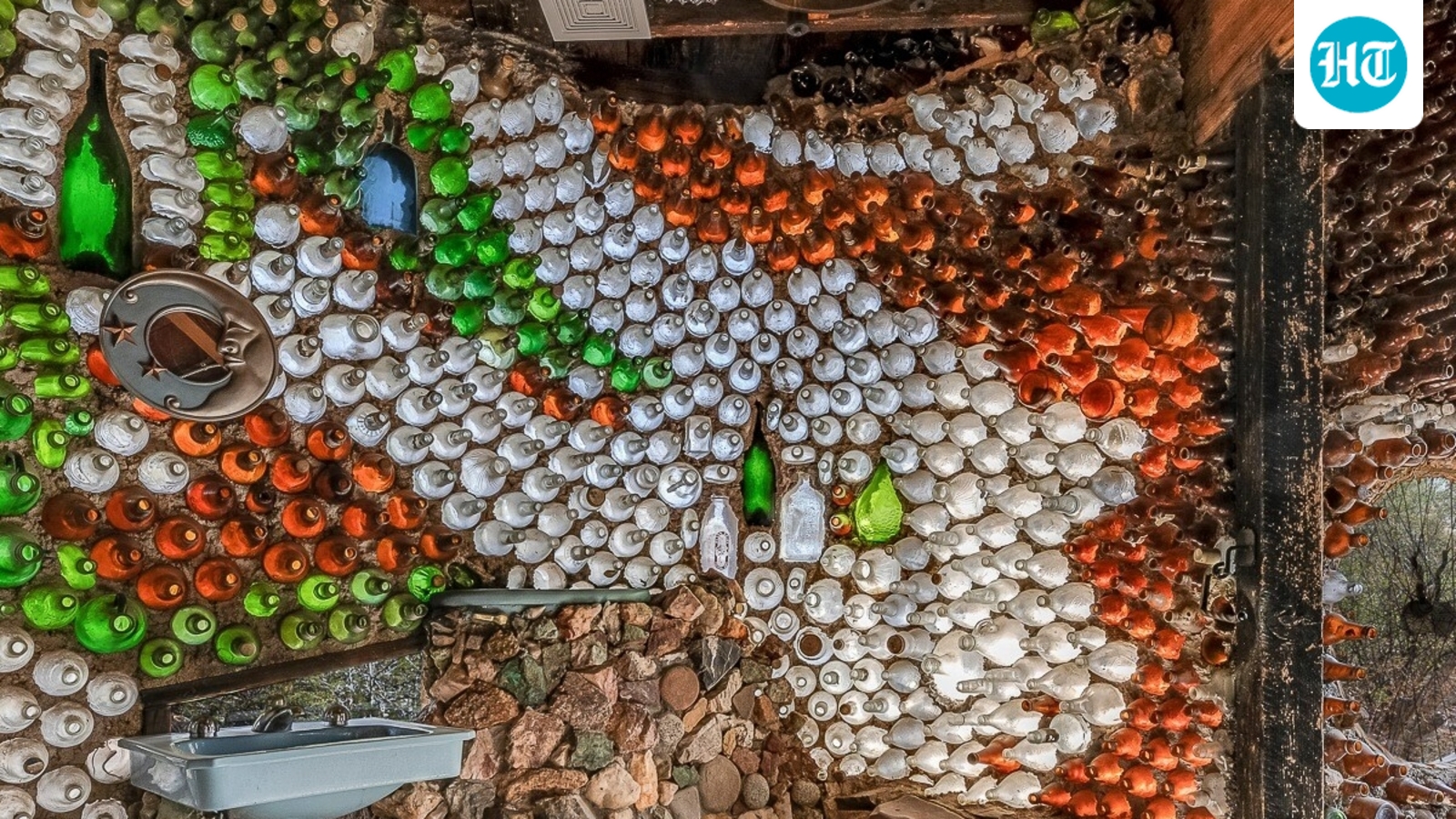 Thousands of glass bottles, set in rock and mortar, form the walls of this Tucson home. (@tucsonbottlehouse/Instagram)